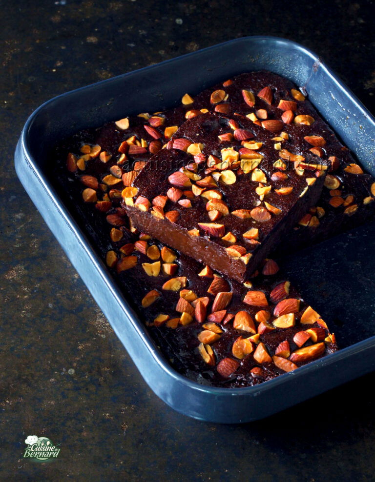 A chocolate cake with almonds in a baking pan.
